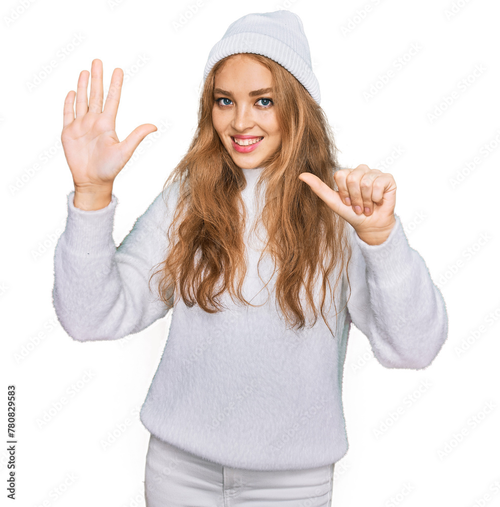 Young caucasian girl wearing wool sweater and winter cap showing and pointing up with fingers number six while smiling confident and happy. Young caucasian girl wearing wool sweater and winter cap showing and pointing up with fingers number six while smiling confident and happy.