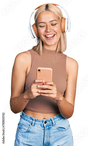 Beautiful young blonde woman using smartphone wearing headphones smiling and laughing hard out loud because funny crazy joke.