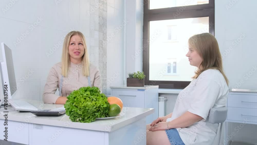 A nutritionist advises a patient on healthy eating habits in a well-lit consultation room. A nutritionist advises a patient on healthy eating habits in a well-lit consultation room.