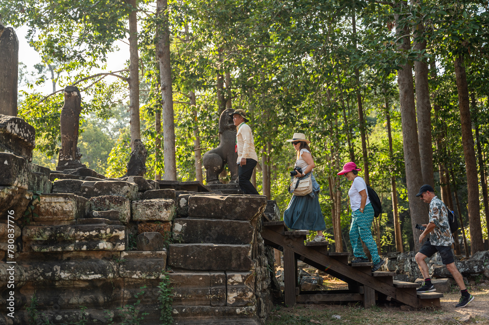 Exploring Ancient Angkor Wat: Tourists at Hindu Temple Exploring Ancient Angkor Wat: Tourists at Hindu Temple
