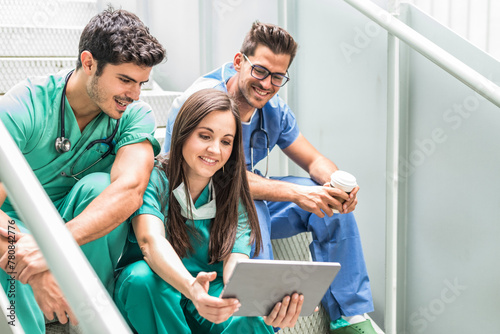 Medics having coffee and watching tablet photo