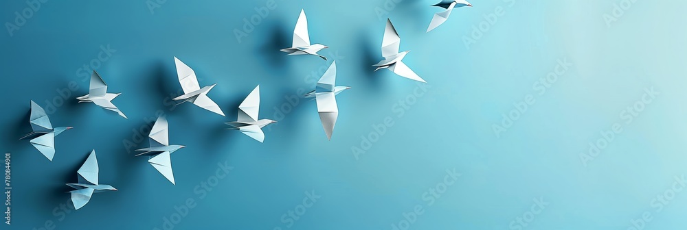 © StockUp - A flock of origami birds flying in formation signifies unity and leading change, with a clear blue background promoting calm