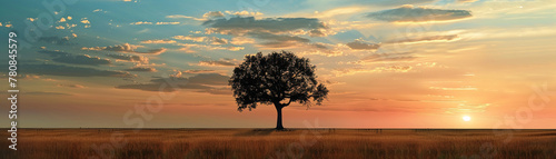 A lone tree stands in the savannah  silhouetted against a sunset sky  embodying solitude and natural grace