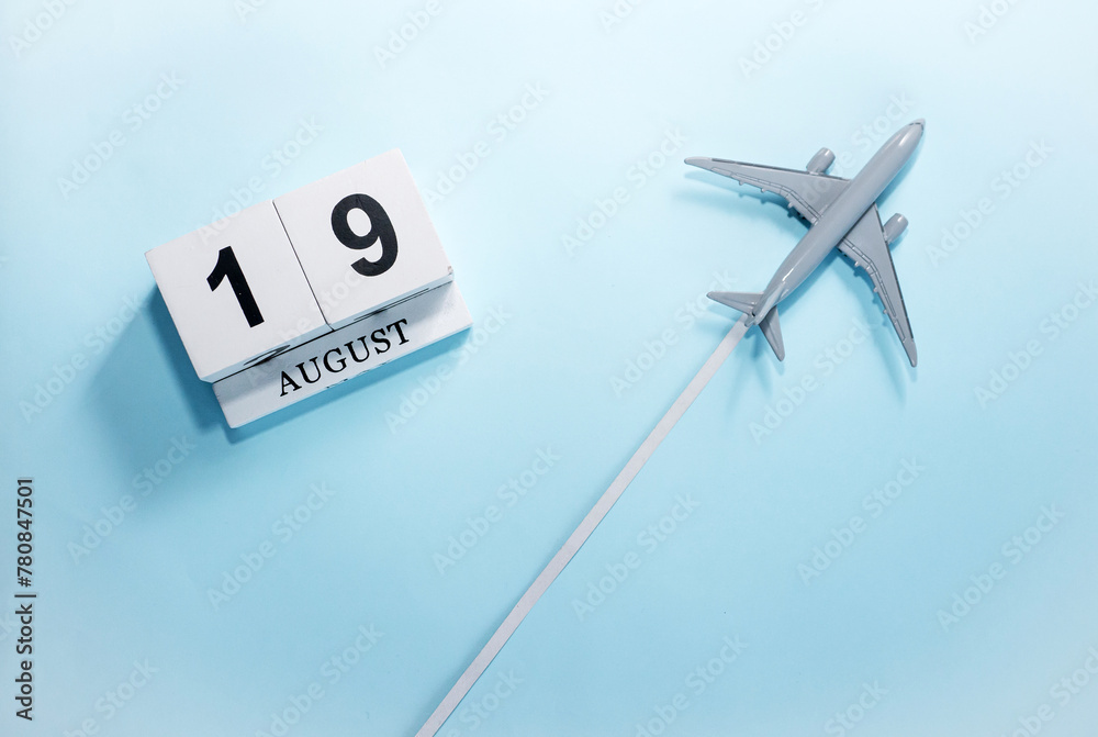 August calendar with number 19. Top view of a calendar with a flying passenger plane. Scheduler. Travel concept. Copy space. August calendar with number 19. Top view of a calendar with a flying passenger plane. Scheduler. Travel concept. Copy space.