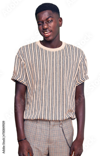 Young african american man wearing casual clothes winking looking at the camera with sexy expression, cheerful and happy face.