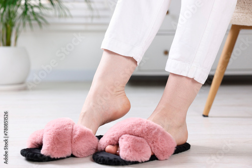 Woman in soft slippers at home, closeup