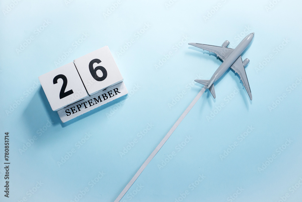 September calendar with number 26. Top view of a calendar with a flying passenger plane. Scheduler. Travel concept. Copy space. September calendar with number 26. Top view of a calendar with a flying passenger plane. Scheduler. Travel concept. Copy space.