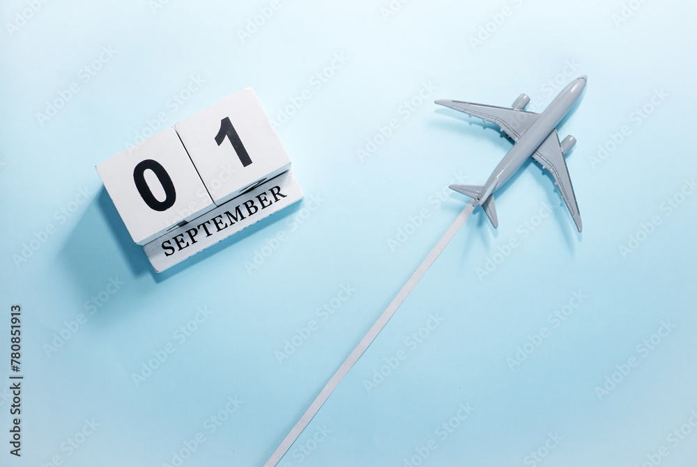 September calendar with number 1. Top view of a calendar with a flying passenger plane. Scheduler. Travel concept. Copy space. September calendar with number 1. Top view of a calendar with a flying passenger plane. Scheduler. Travel concept. Copy space.