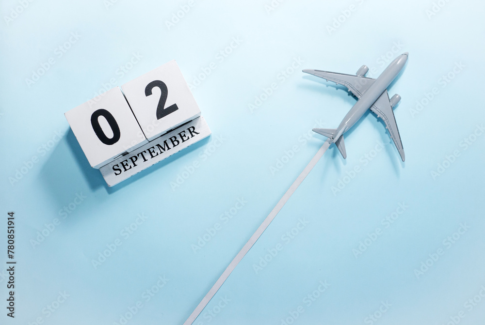 September calendar with number 2. Top view of a calendar with a flying passenger plane. Scheduler. Travel concept. Copy space. September calendar with number 2. Top view of a calendar with a flying passenger plane. Scheduler. Travel concept. Copy space.