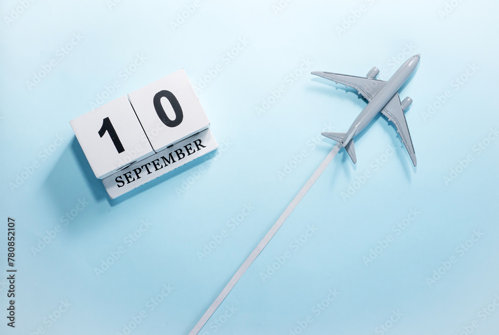 September calendar with number 10. Top view of a calendar with a flying passenger plane. Scheduler. Travel concept. Copy space. September calendar with number 10. Top view of a calendar with a flying passenger plane. Scheduler. Travel concept. Copy space.