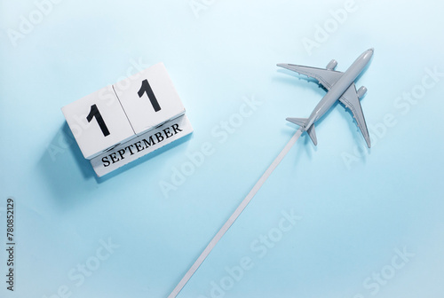 September calendar with number  11. Top view of a calendar with a flying passenger plane. Scheduler. Travel concept. Copy space. photo