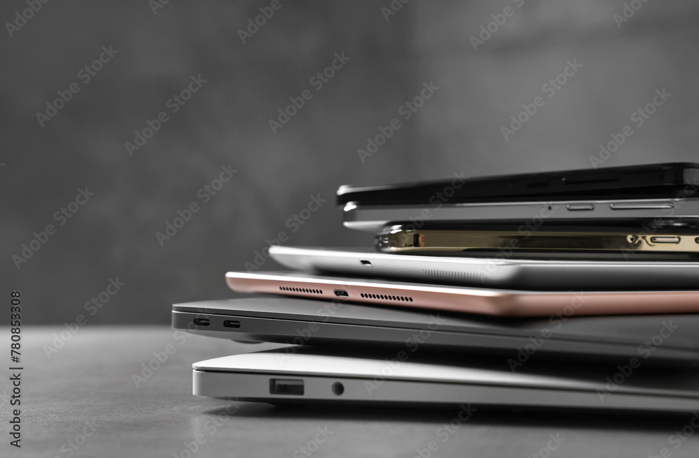 Many different modern gadgets on grey table, closeup. Space for text Many different modern gadgets on grey table, closeup. Space for text