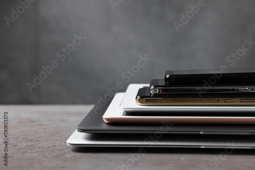Many different modern gadgets on grey table. Space for text © New Africa