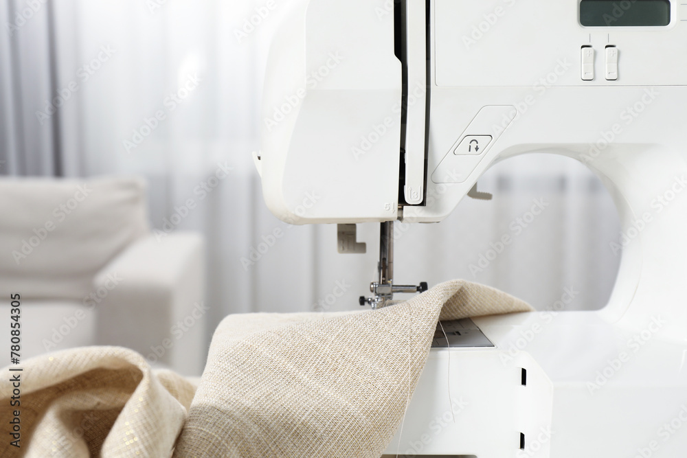 Fototapeta premium White sewing machine and fabric indoors, closeup