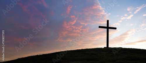 cross on the hill in sunrise with pink sky. 