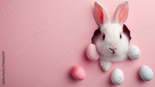 Easter bunny with Easter eggs peeks out from a hole in the wall. Pink background. Copy space for text. Concept Easter Holiday. Design of cards, posters.