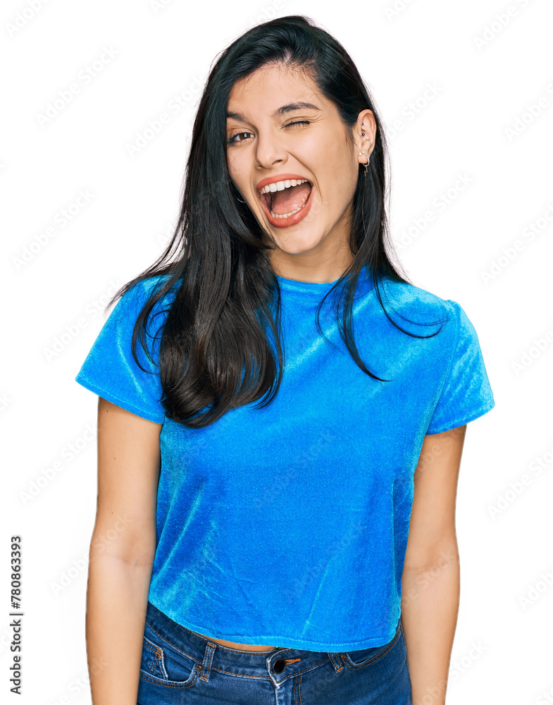 Young hispanic woman wearing casual clothes winking looking at the camera with sexy expression, cheerful and happy face. Young hispanic woman wearing casual clothes winking looking at the camera with sexy expression, cheerful and happy face.