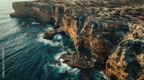 A stunning aerial view of a cliff overlooking the ocean. Perfect for travel and nature concepts