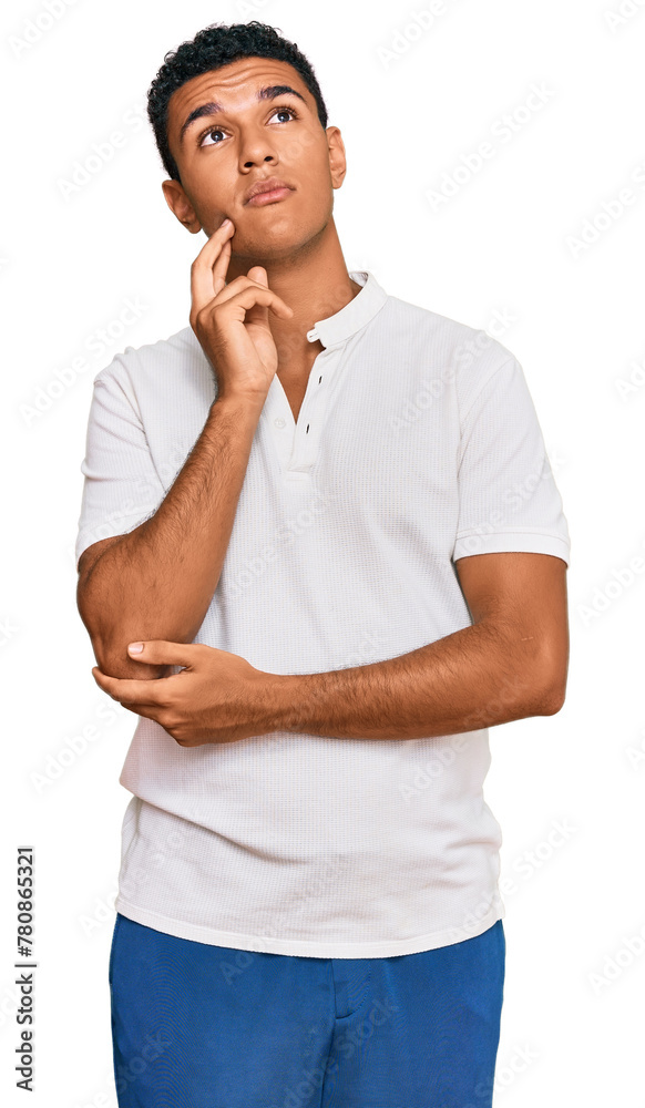 Young arab man wearing casual clothes with hand on chin thinking about question, pensive expression. smiling and thoughtful face. doubt concept. Young arab man wearing casual clothes with hand on chin thinking about question, pensive expression. smiling and thoughtful face. doubt concept.