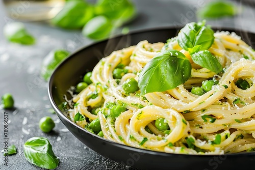 Green vegetable pasta in black bowl on grey stone background close up