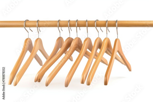 Several wooden hangers hanging on a bar with white background photo