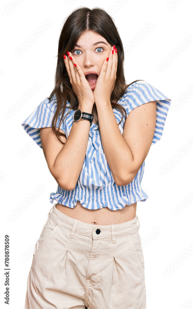 Young beautiful caucasian girl wearing casual clothes afraid and shocked, surprise and amazed expression with hands on face Young beautiful caucasian girl wearing casual clothes afraid and shocked, surprise and amazed expression with hands on face