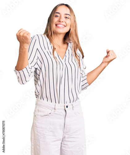 Young beautiful blonde woman wearing casual clothes screaming proud, celebrating victory and success very excited with raised arms photo