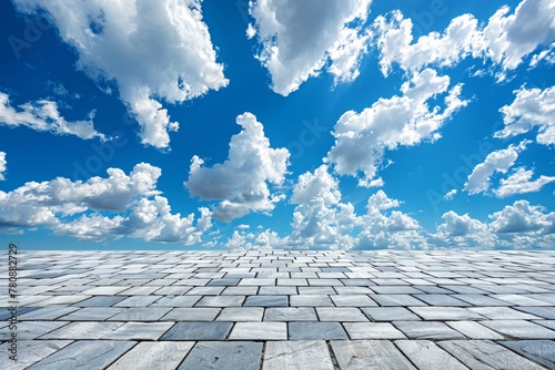 paving slabs and bright sky with clouds.  background with perspective.  place for creative text, advertising