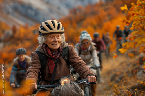 An elderly woman cycles through a trail adorned with fall foliage, displaying vitality and enjoyment of life.