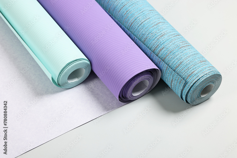 Different stylish wallpaper rolls on light background Different stylish wallpaper rolls on light background