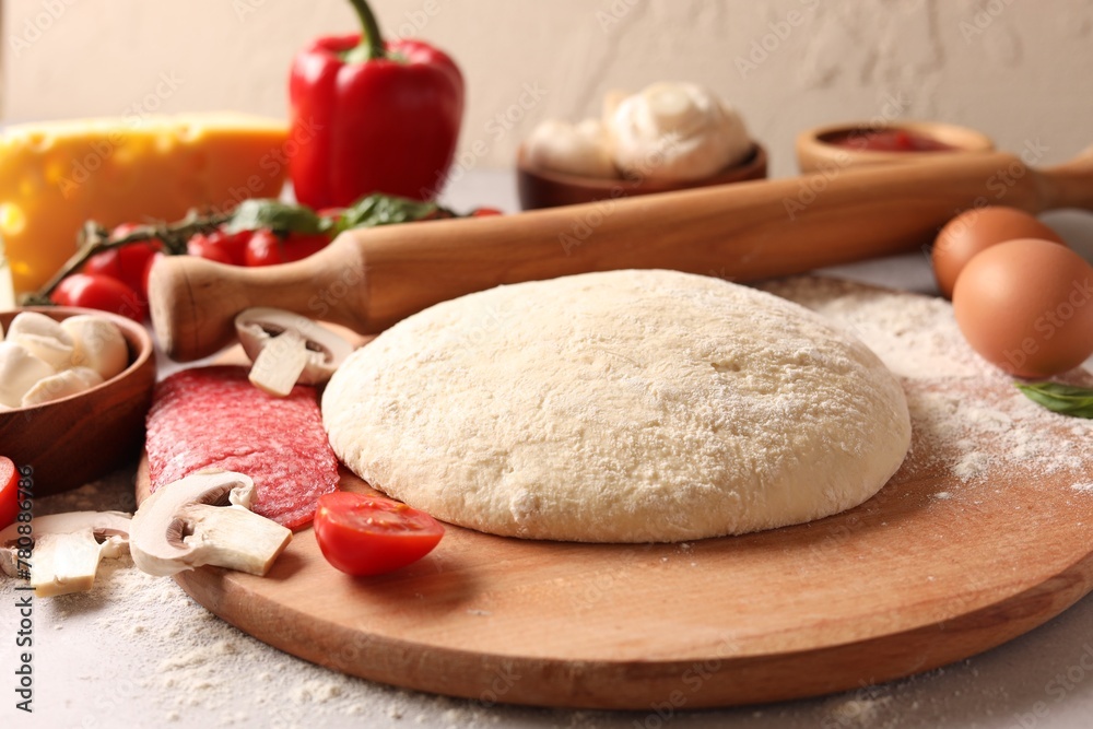 Pizza dough, products and rolling pin on gray table, closeup Pizza dough, products and rolling pin on gray table, closeup