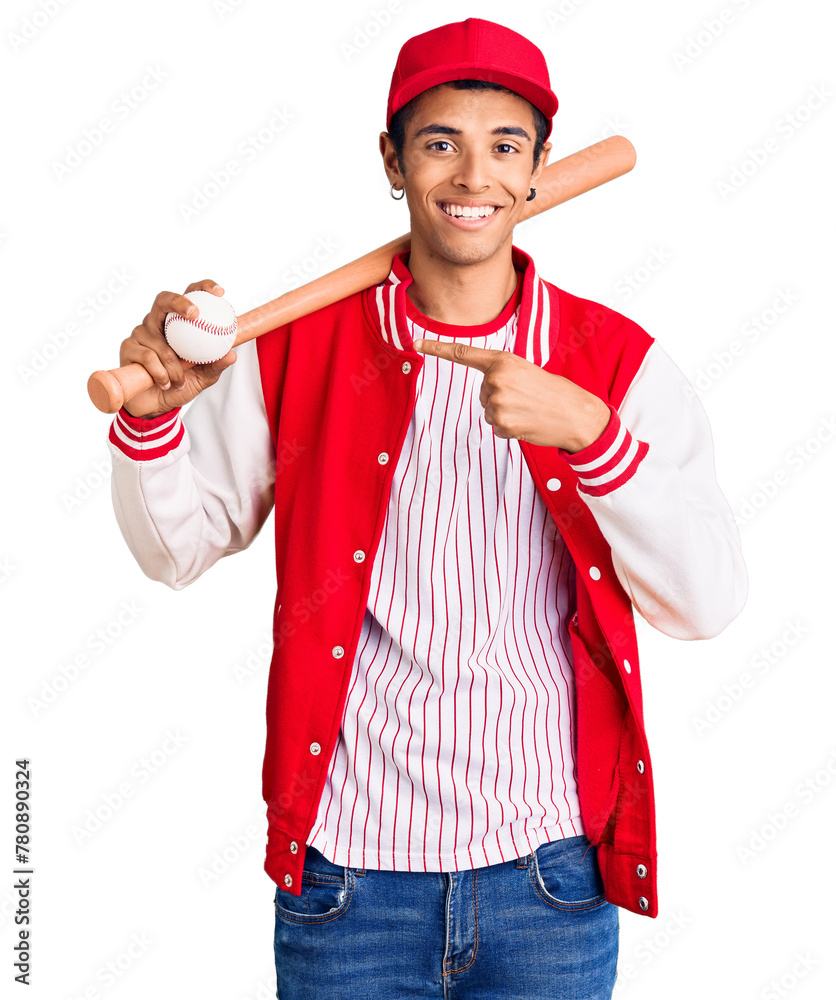 Young african amercian man playing baseball holding bat and ball smiling happy pointing with hand and finger