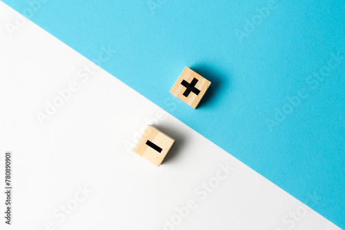 Obraz na plátně The concept of opposites or pros and cons using plus and minus signs