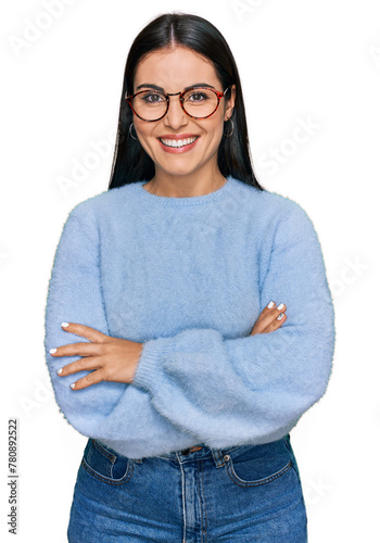 Young hispanic woman wearing casual clothes and glasses happy face smiling with crossed arms looking at the camera. positive person.