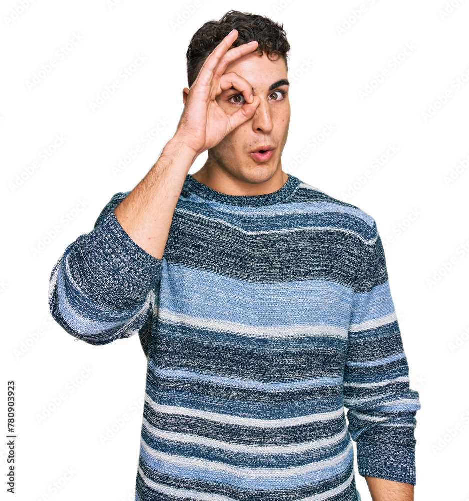Hispanic young man wearing casual clothes doing ok gesture shocked with surprised face, eye looking through fingers. unbelieving expression. Hispanic young man wearing casual clothes doing ok gesture shocked with surprised face, eye looking through fingers. unbelieving expression.