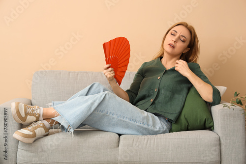 Mature woman with fan suffe...