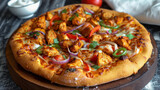 Spicy chicken tikka pizza on wooden board