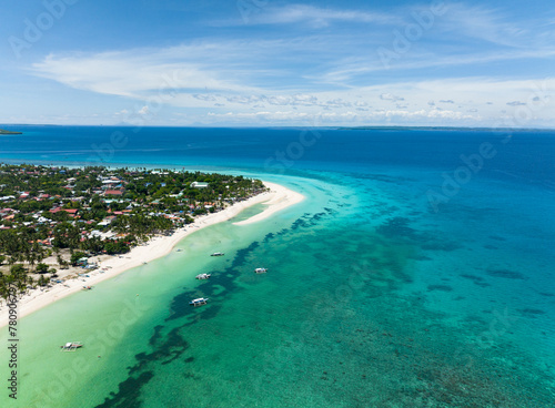 Flying over a beautiful sandy beach and a blue ocean. Bantayan island, Philippines.
