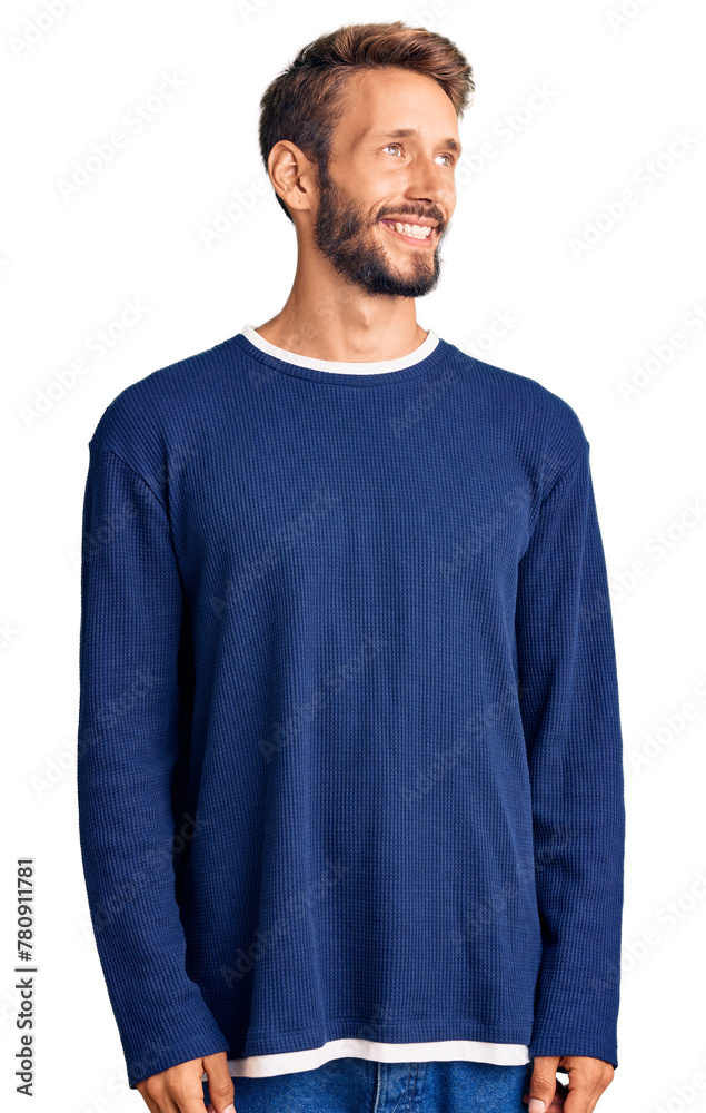 Handsome blond man with beard wearing casual sweater looking away to side with smile on face, natural expression. laughing confident. Handsome blond man with beard wearing casual sweater looking away to side with smile on face, natural expression. laughing confident.