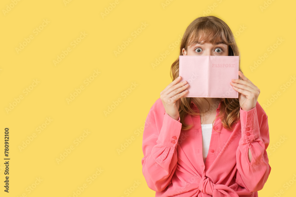 Young surprised woman with passport on yellow background Young surprised woman with passport on yellow background
