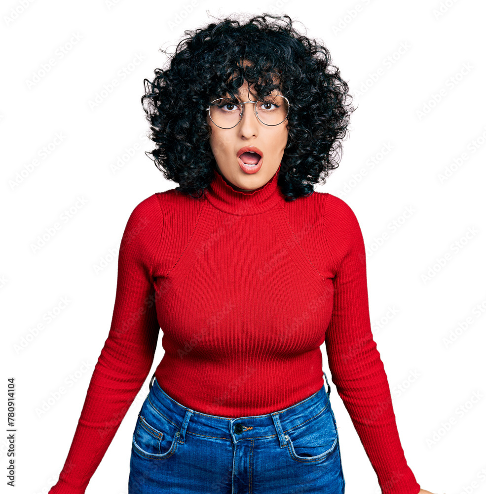 Young middle east girl wearing casual clothes and glasses afraid and shocked with surprise and amazed expression, fear and excited face. Young middle east girl wearing casual clothes and glasses afraid and shocked with surprise and amazed expression, fear and excited face.