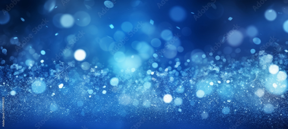 Blue abstract glowing bokeh background with snowflakes