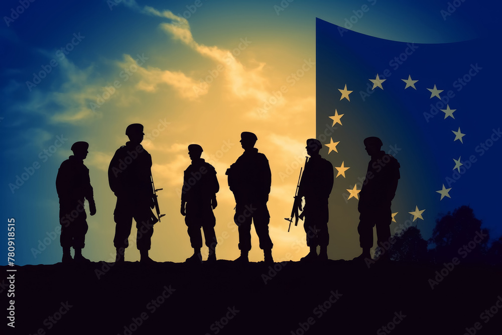 Silhouettes of NATO military personnel standing against an illuminated NATO flag
