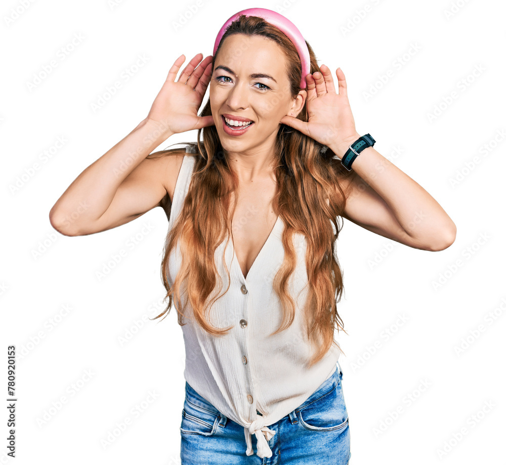Naklejka premium Young caucasian woman wearing casual style with sleeveless shirt trying to hear both hands on ear gesture, curious for gossip. hearing problem, deaf