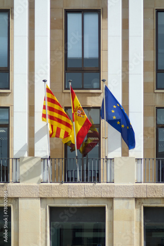 The flags of Spain, Catalonia, and Europe fluttering in the wind, symbolizing unity, diversity, and coexistence in the European community.
 photo