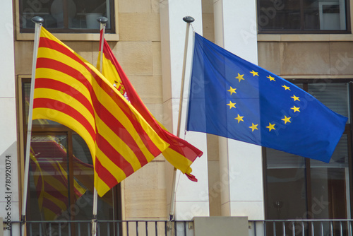 Vibrant Spanish, Catalan, and European flags flutter together, their colors a testament to the rich cultural tapestry and shared history. photo