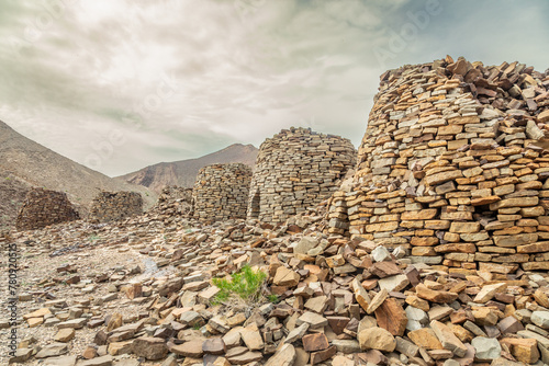 Ancient stone beehive tombs with Jebel Misht mountain in the background, archaeological site near al-Ayn, sultanate Oman