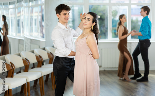 Couple in festive clothes learn to dance latin american dance bachata in studio © JackF
