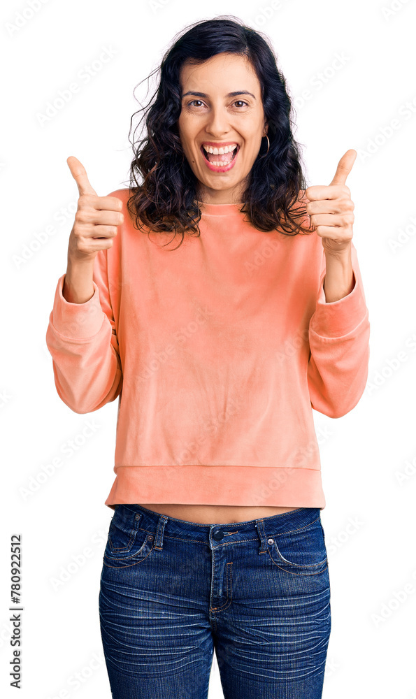 Young beautiful hispanic woman wearing casual clothes success sign doing positive gesture with hand, thumbs up smiling and happy. cheerful expression and winner gesture.