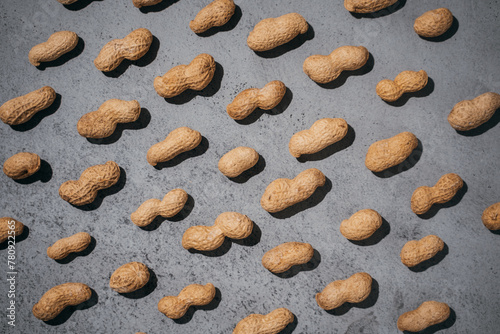 peanuts closed on a gray concrete background, lots of nuts, top view, flatlay